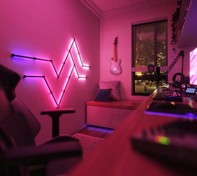 Office bedroom setup with Nanoleaf Lines RGB lights mounted above the desk and monitor. The perfect gaming lights for your PC battlestation.
